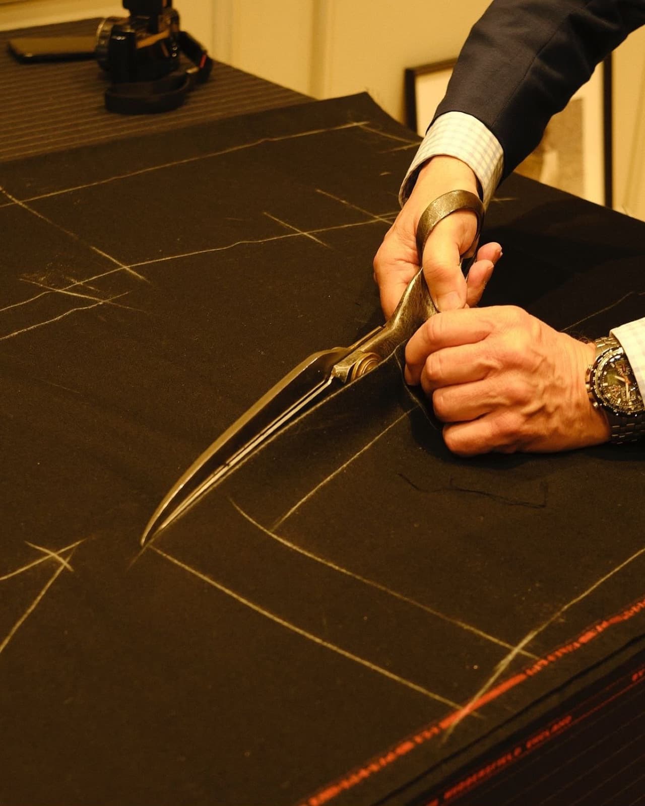 Hand-cutting cloth along chalk pattern lines